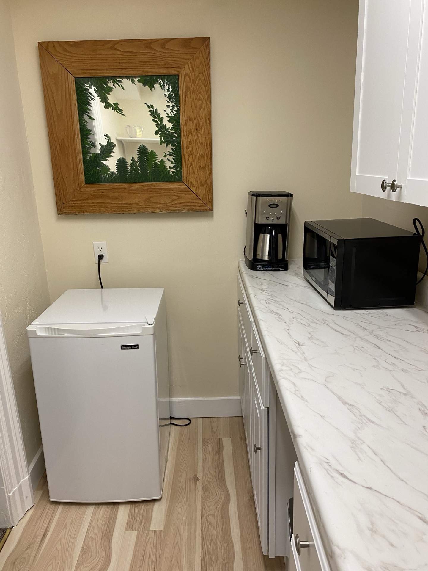 Kitchenette with mini fridge, microwave, and marble counter at The Phillips Mansion