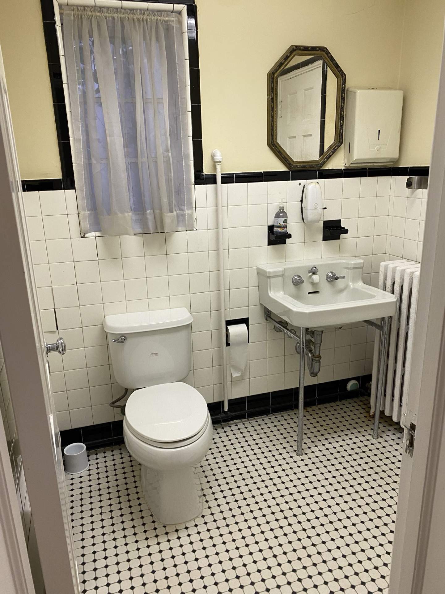 Black and white tile bathroom in vintage style at The Phillips Mansion